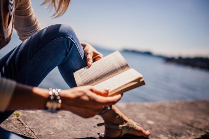 Girl reading book on beach